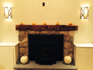 Millstone Masonry built this extraordinary rustic stone fireplace surround. The mantel is a reclaimed beam from the original structure.